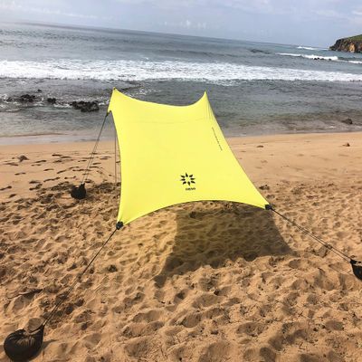Neso Portable Beach Tent Sun Shelter with Sand Anchor - Lightweight Beach Shade Canopy - Easy Setup for Family Outings - Patented Reinforced Corners - UPF 50+ Sun Protection - 7 x 7ft - Lemon