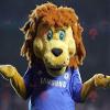 SPOTSOUND Yellow and brown lion REDBROKOLY Mascot in blue sportswear view 1