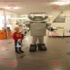 SPOTSOUND Very realistic metallic gray robot REDBROKOLY Mascot view 1