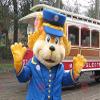 SPOTSOUND Orange cat REDBROKOLY Mascot dressed as a train controller view 1
