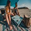 Neso Beach Table - Lightweight, Portable and Foldable Table for Beach, Camping and Outdoor Adventures - Stable Surface - with Cup Holder for Drinks and Phone Pockets - Aqua Fronds view 2